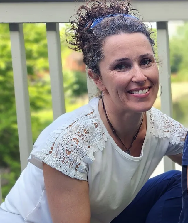 Cathy King, Co-Founder and Teacher, smiling outdoors